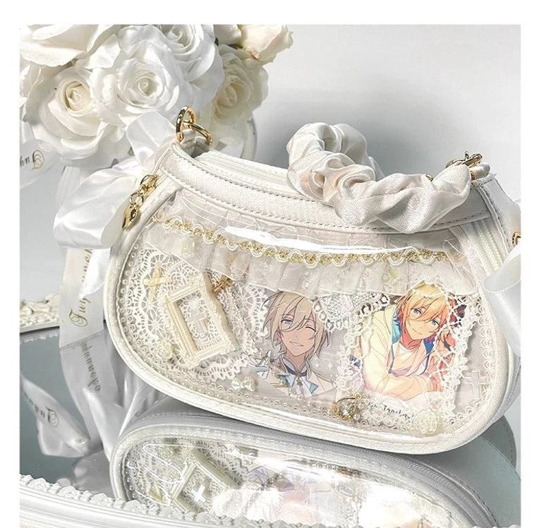 Jirai Kei mini ita bag white colorway shown in side-front view with gold-tone metal hardware, lace-trimmed clear display window, and satin bow details against white artificial rose styling