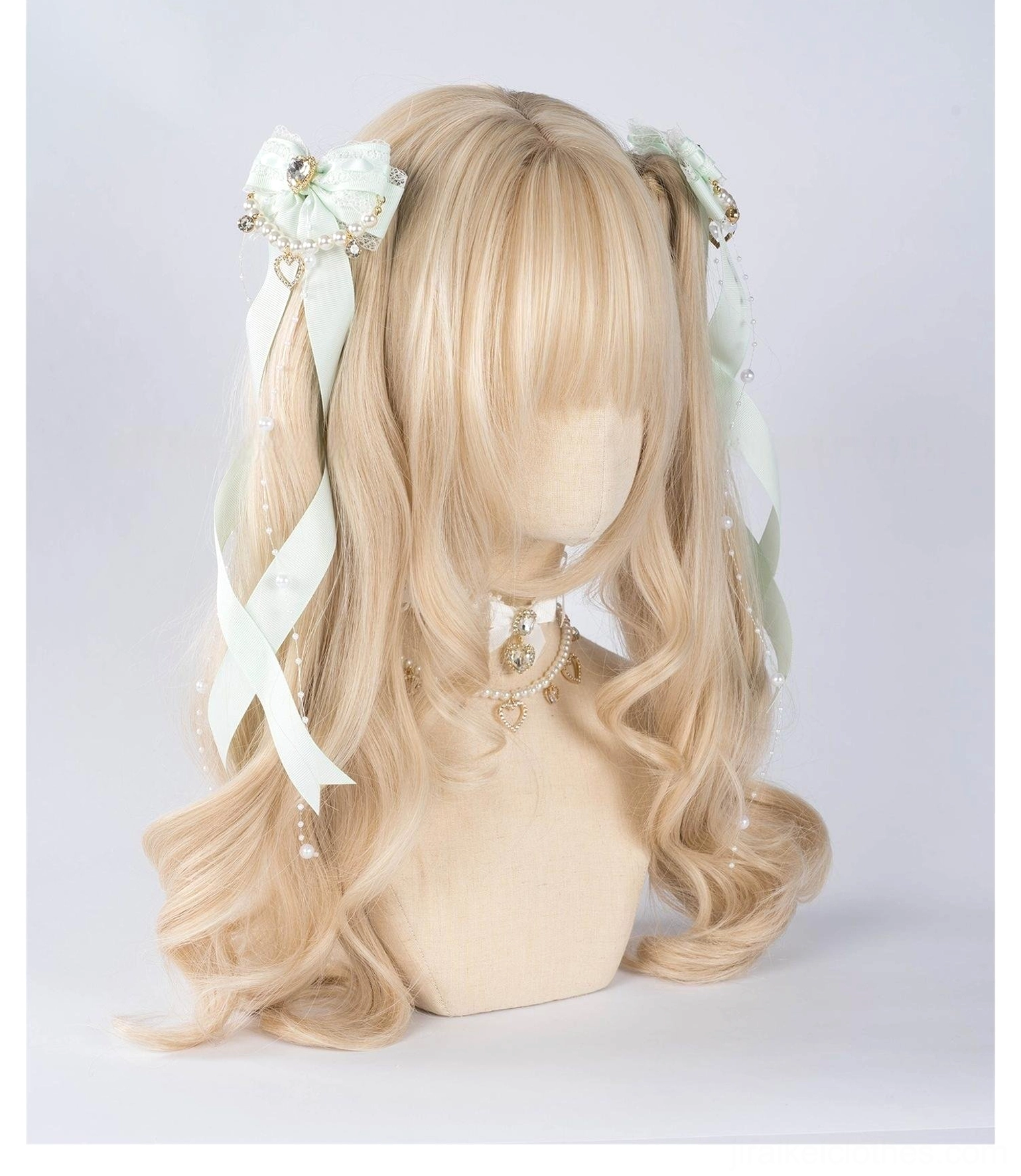 Jirai Kei mint green ribbon bow hair clips with pearl chain trim and pearl decorative choker displayed on mannequin head front view