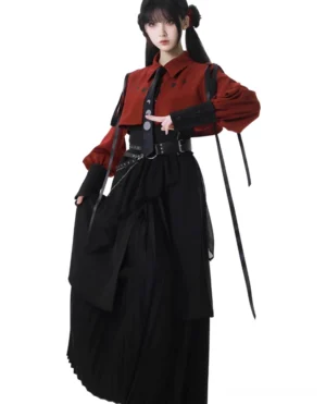 Jirai Kei aesthetic three-quarter front view showcasing moon-patterned black tie, decorative waist chain belt details, and architectural pleated skirt silhouette on model with gothic styling