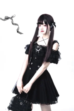 Jirai Kei off-shoulder gothic lolita blouse with tiered ruffles and heart adornments front three-quarter view on model with twin-tail hairstyle