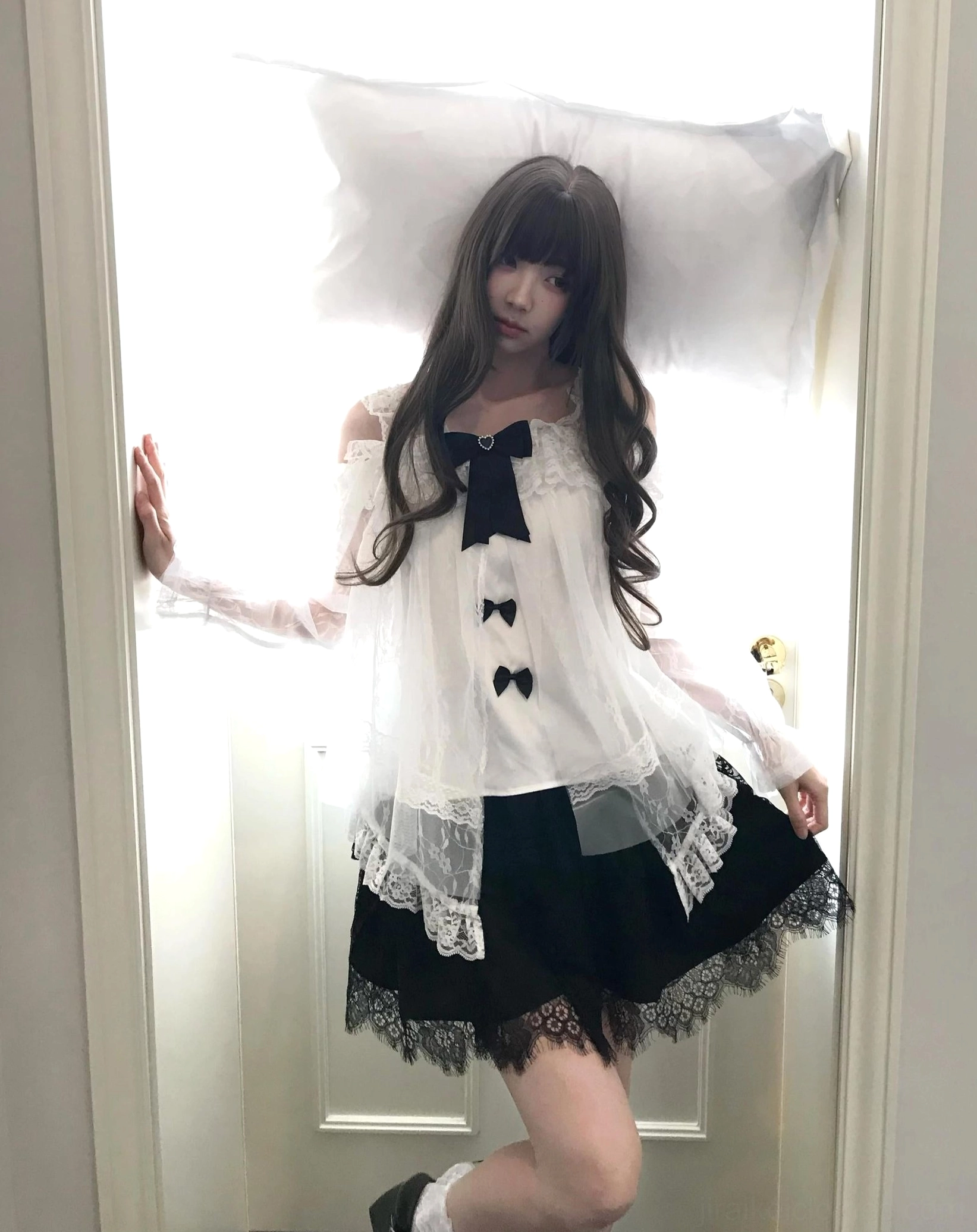 Jirai Kei off-shoulder blouse with detachable bows and swan feather tulle skirt set worn indoors, showing full-body front view of black-and-white lace ensemble with ruffled collar and layered skirt