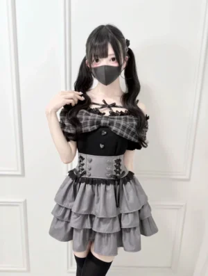 Black-gray plaid Jirai Kei off-shoulder bow t-shirt with ruffled collar and matching layered skirt, worn by model with twin-tails