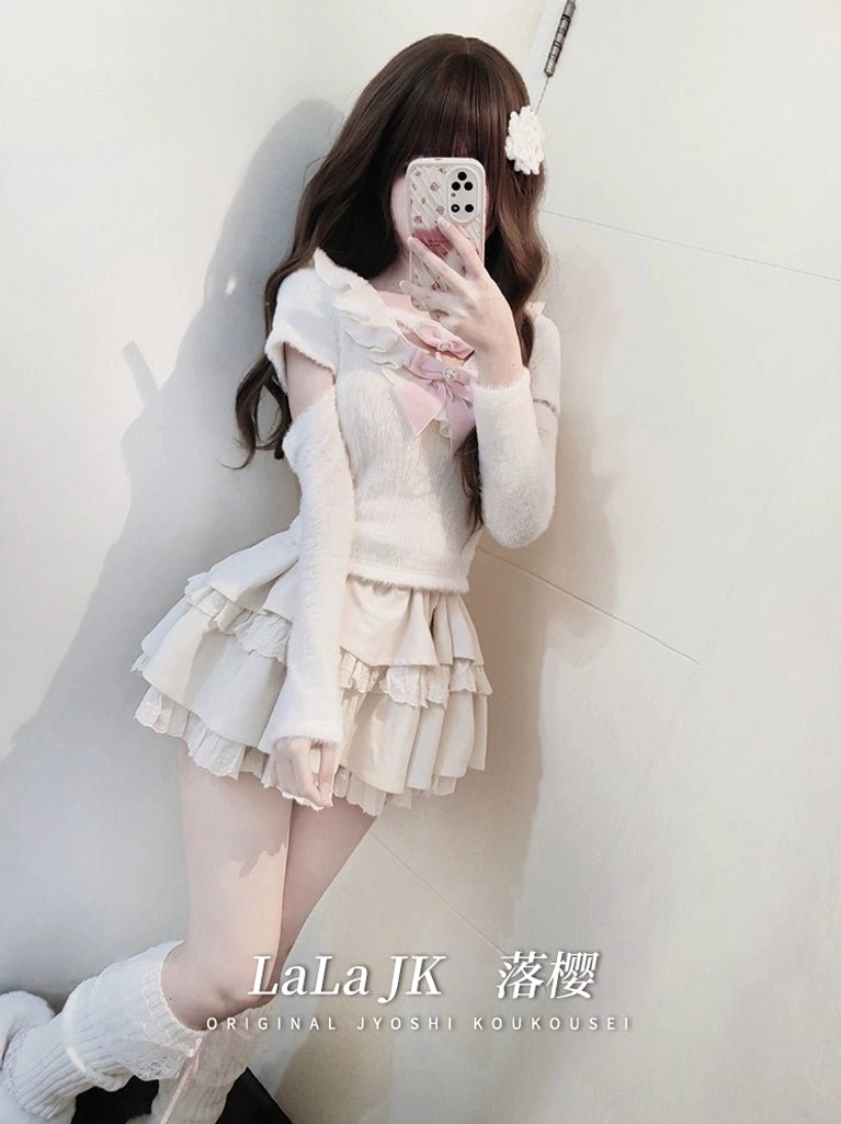 Jirai Kei white sweater and ruffle skirt outfit demonstrating off-shoulder construction with detachable long sleeves and pearl bow ornament placement, standing posture highlighting silhouette