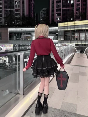 Back view of Jirai Kei fashion set displaying back zipper on black layered skirt, cross coffin handbag, and complete silhouette of wine-red blouse with burgundy lace details