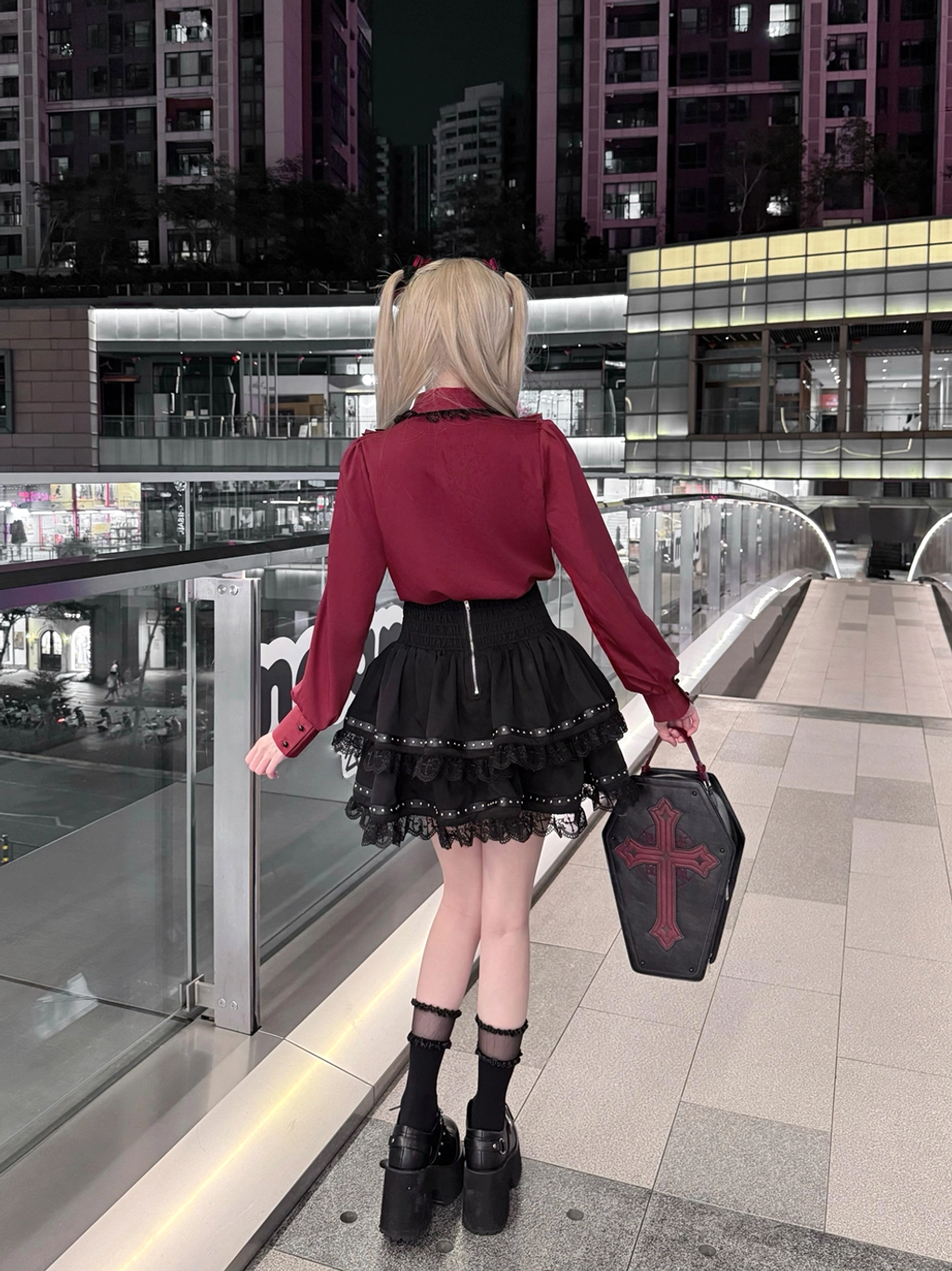 Back view of Jirai Kei fashion set displaying back zipper on black layered skirt, cross coffin handbag, and complete silhouette of wine-red blouse with burgundy lace details