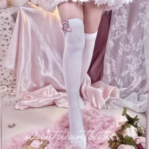 Light gray Jirai Kei over-the-knee lace socks worn on model's leg rear view showing thigh-high length and small bow ornament at cuff opening on satin backdrop
