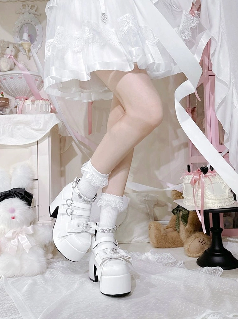 Pastel pink Jirai Kei platform heels with thick block heel and rhinestone buckles, displayed in girly aesthetic bedroom environment