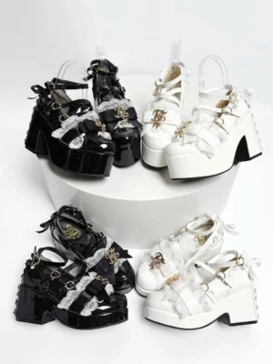 Jirai Kei platform heels flat lay top view showing patent leather black and white colorways with crisscross buckle straps and gold charm details