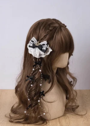 Jirai Kei lace pearl crown hair clip with rhinestone bow and tassel chain on brown curly wig mannequin - right side view