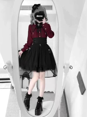 Full-body frontal view of complete Jirai Kei two-piece outfit featuring white peter pan collar blouse with pointed lapels and removable bow, paired with black high-waist skirt with lace hem overlay and side buckle straps, styled with platform boots and lace stockings in mirror setting