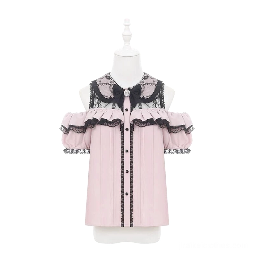 Pink and black Jirai Kei off-shoulder blouse with lace patchwork and rhinestone bow displayed on dress form showing romantic Gothic lolita aesthetic and ruffled sleeve construction