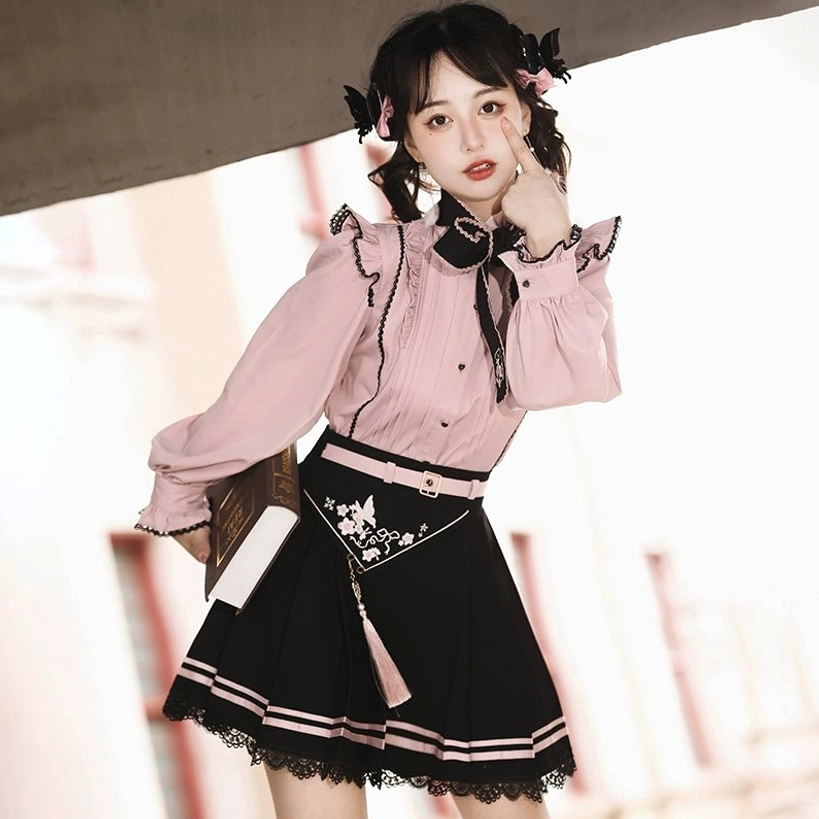 Close-up side profile of pink Jirai Kei blouse with puffed trumpet sleeves, ruffled cuffs, and dual-tone color scheme, European street setting