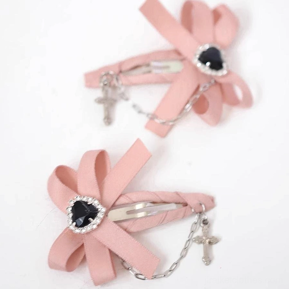 Pair of pink ryousangata Jirai Kei bow hair clips satin fabric heart gem cross chain pendants decorative accents