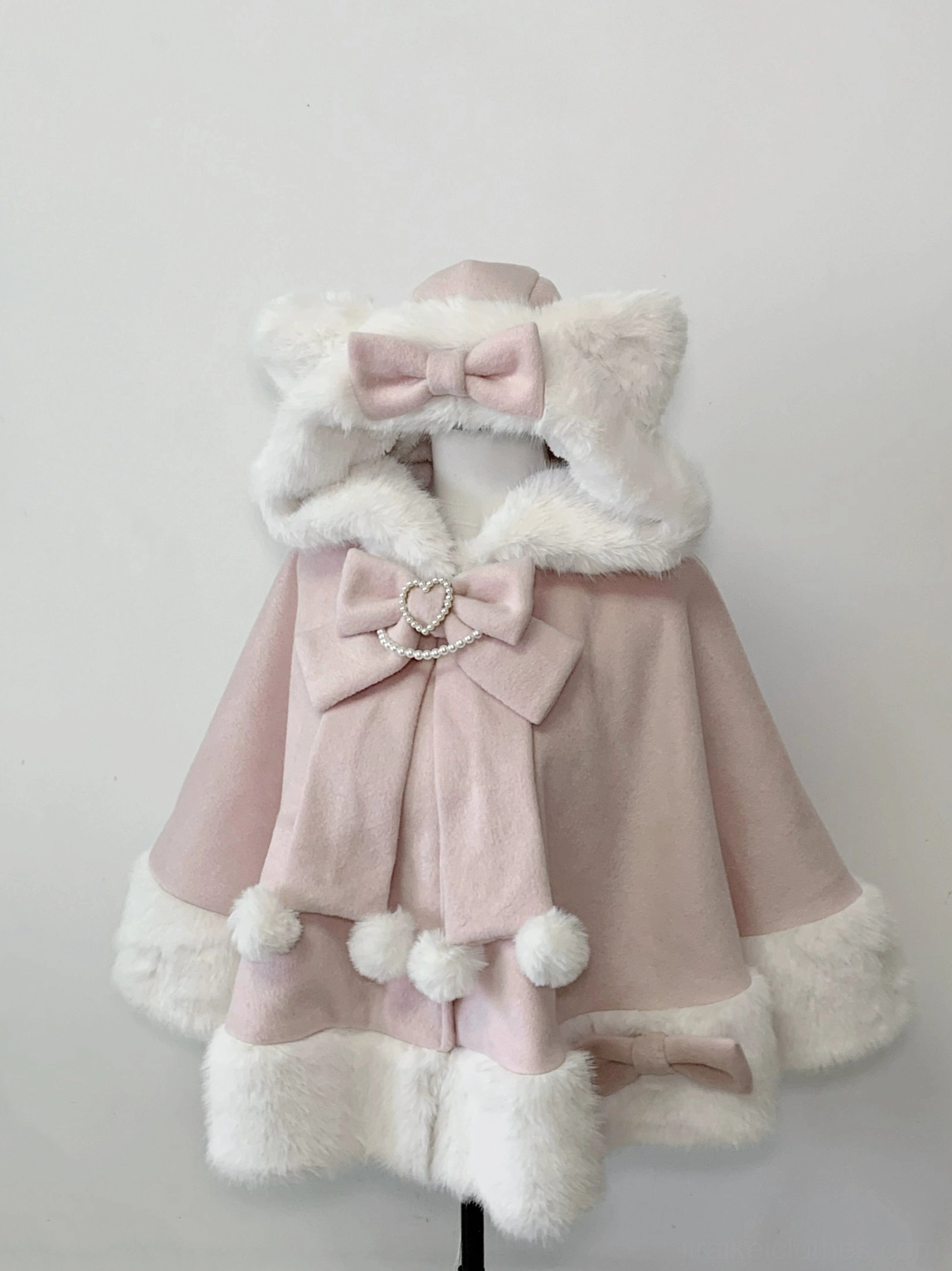 Jirai Kei pink cat ear hooded plush cape with fuzzy white fur trim and detachable heart crystal bows front view on mannequin