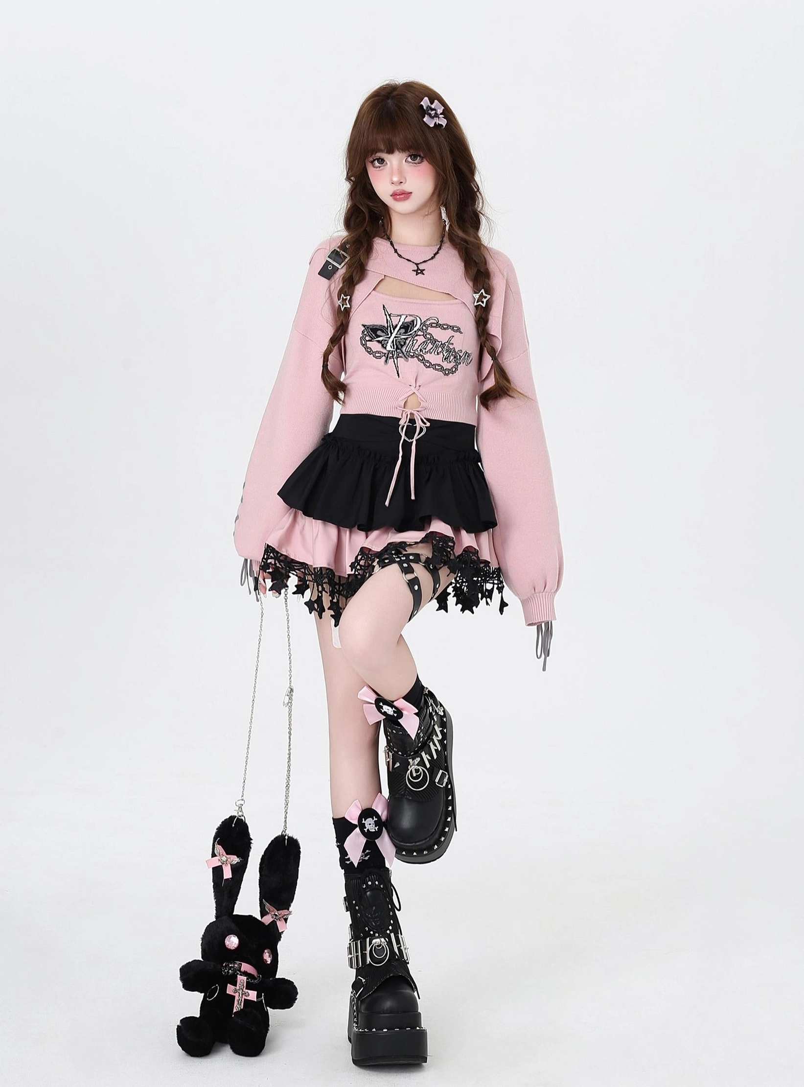 Jirai Kei two-piece knit set pink cutout bolero camisole with bunny plush pendant and lifted leg pose detail
