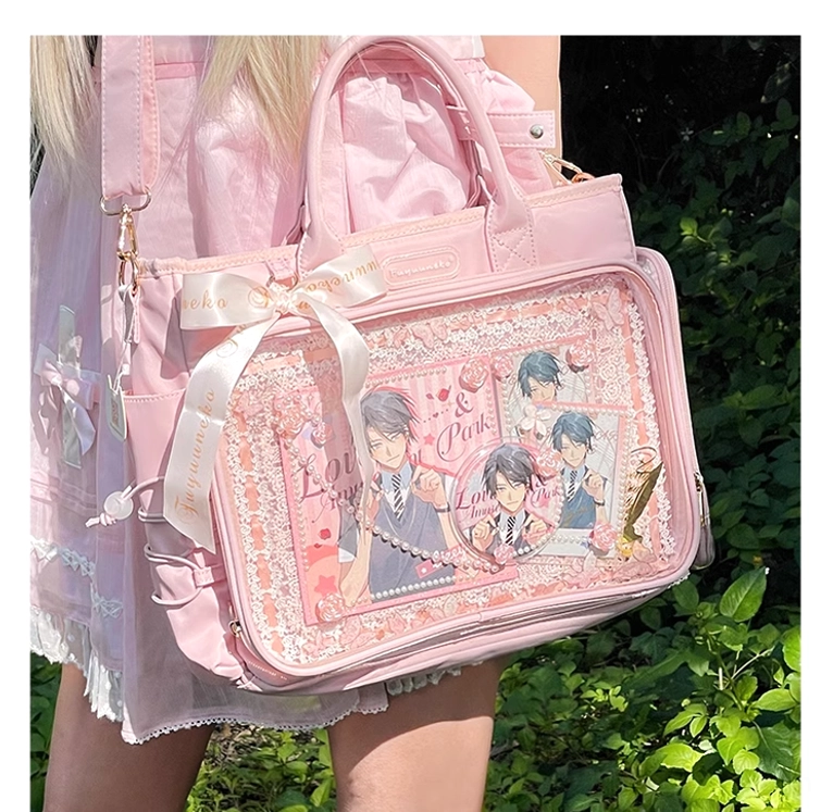 Pink Jirai Kei itabag worn as shoulder bag on model in outdoor garden with green foliage, paired with matching pink Lolita dress and satin bow accent