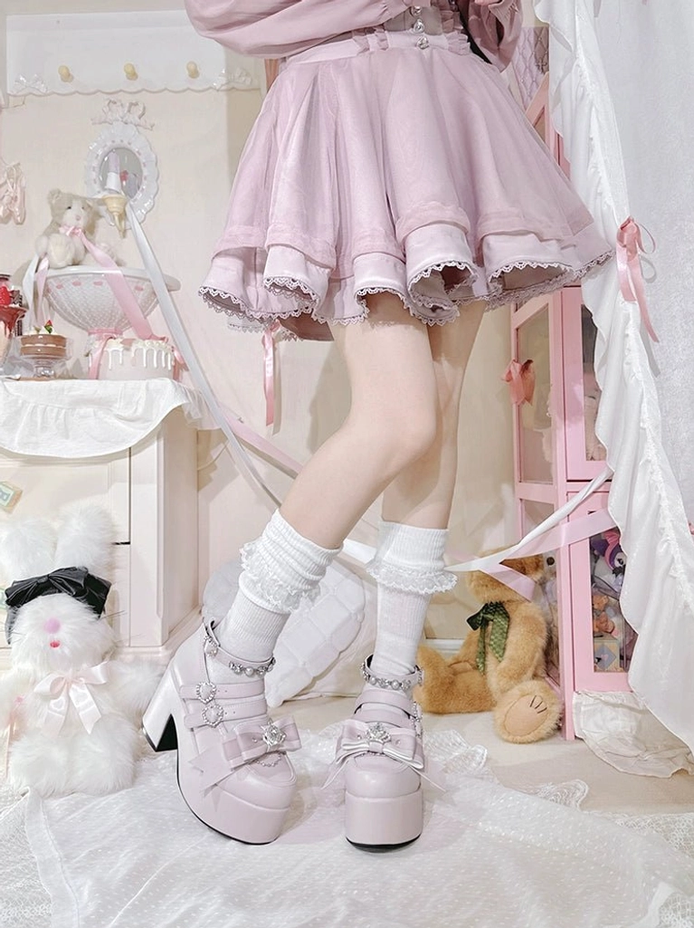 Pastel pink Jirai Kei platform chunky heel shoes with rhinestone buckle straps, paired with ruffled pink mini skirt in bedroom decor