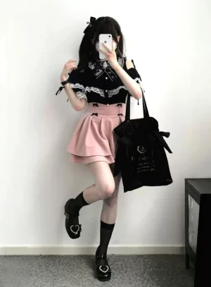 Young woman wearing pink double-layer puff Jirai Kei skirt with black heart-decorated shoes in full-body mirror selfie pose