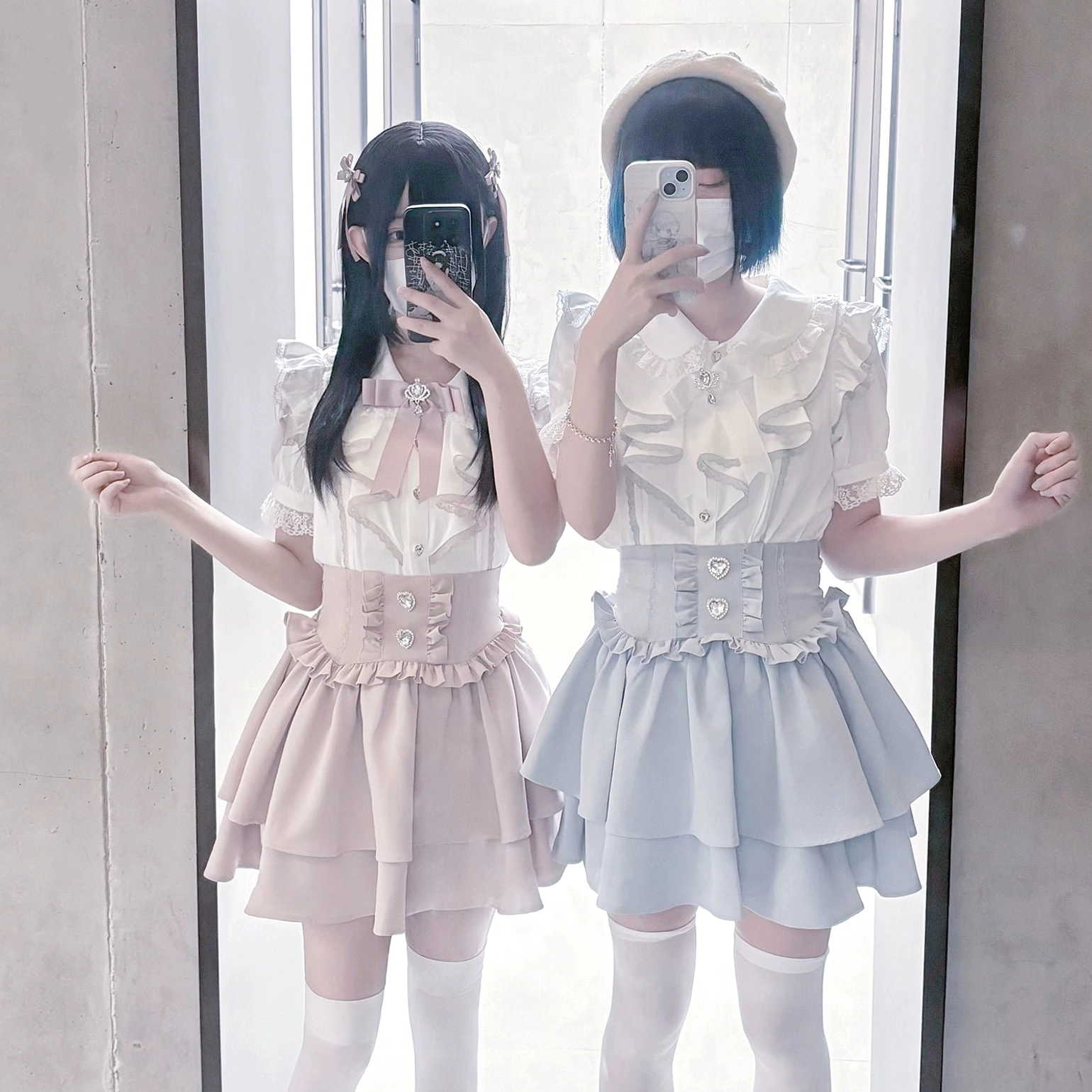 Blush pink jirai kei mini skirt set with puffed short sleeves and bow neck detail, double ruffled skirt, half-body mirror selfie of two models