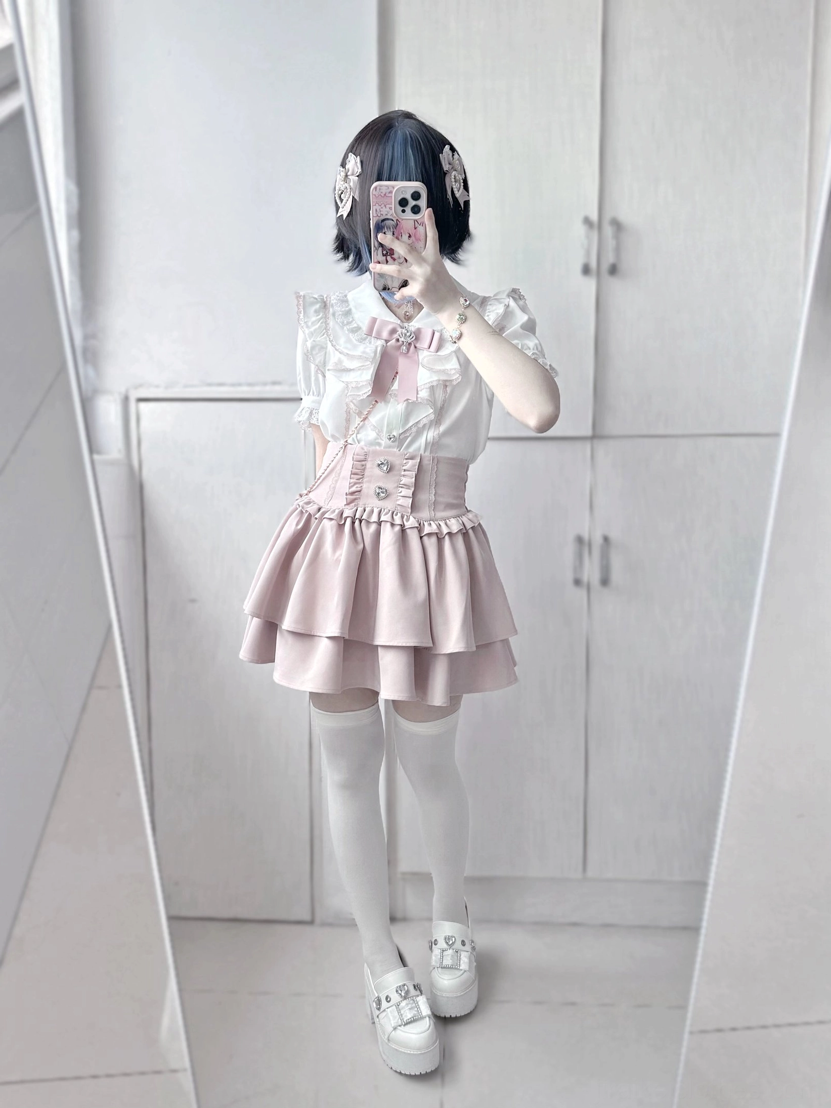 Pink jirai kei tiered mini skirt on figure, soft pastel colorway, ruffled layers with heart rhinestone ornaments, romantic aesthetic