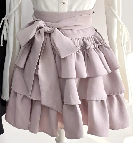 Dusty pink tiered ruffle skirt back close-up view high-waisted design detachable waist bow layered ruffle hem mannequin