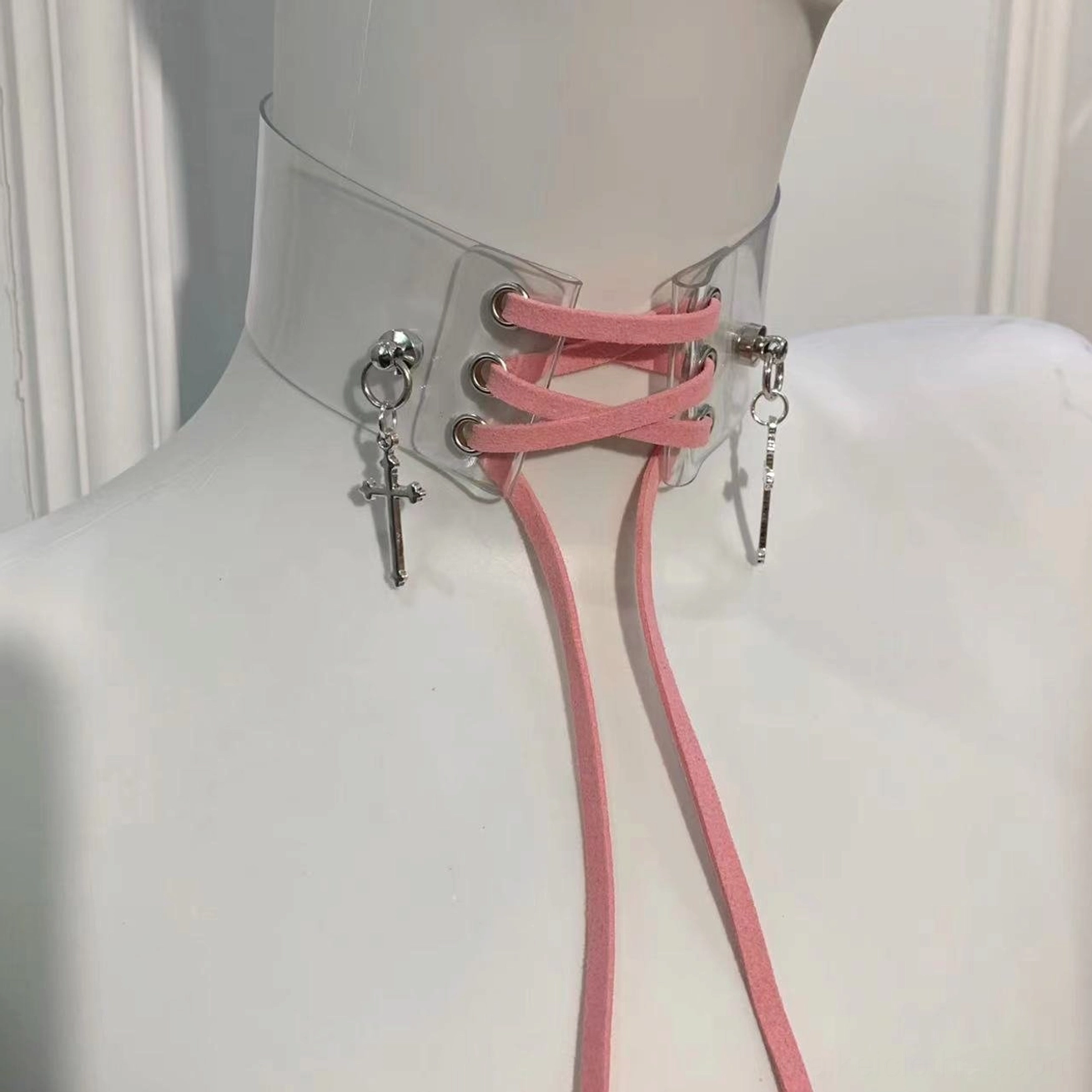 Pink Jirai Kei transparent choker necklace with light pink adjustable lace straps and silver cross pendants, front close-up view