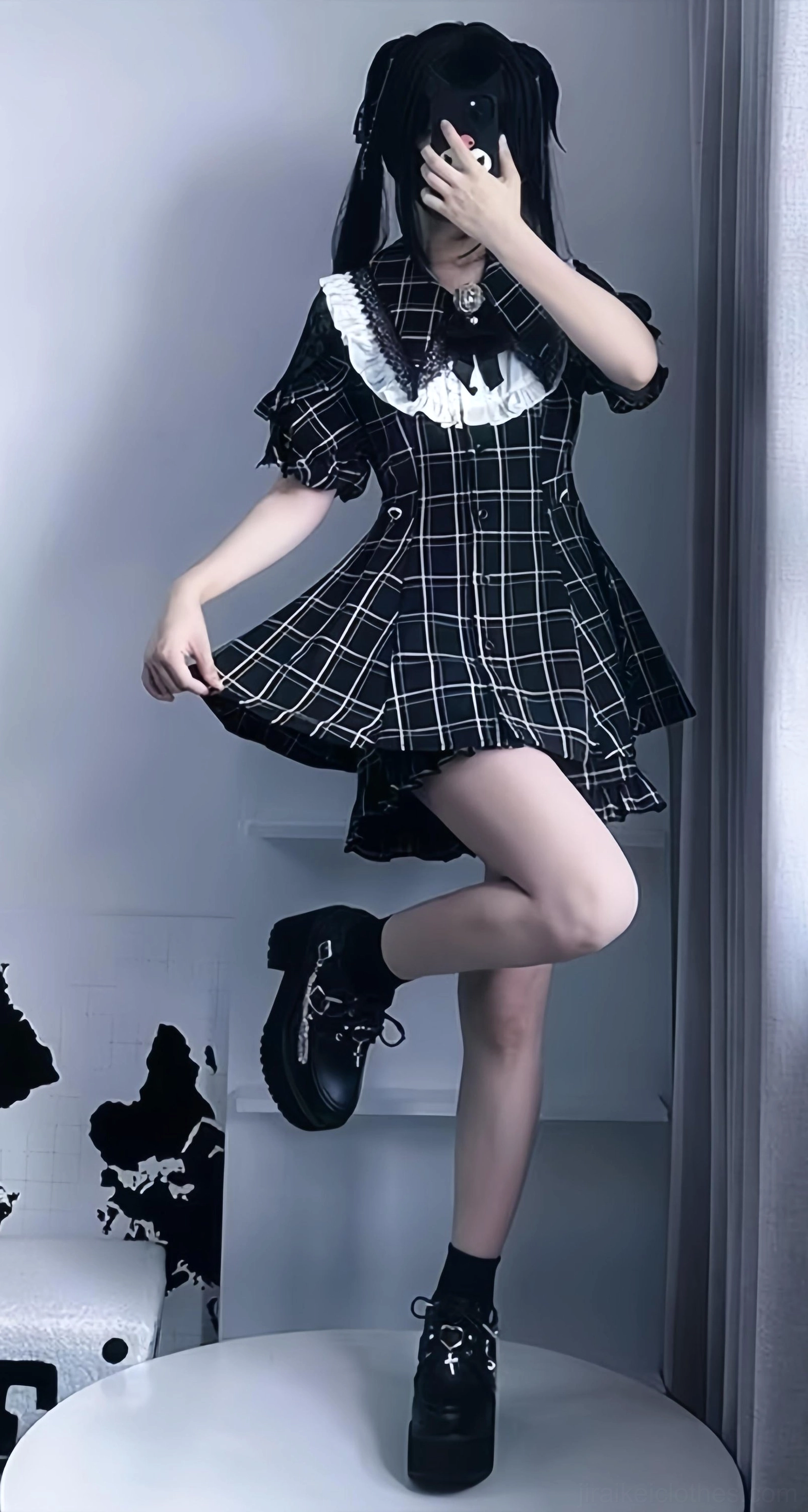 Plaid Jirai Kei dress set dynamic side pose with ruffled hem and lifted leg wearing platform shoes in studio setting