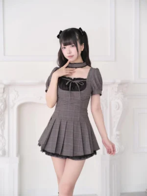 twin-tail girl wearing brown plaid jirai kei dress with matching choker and platform boots fireplace background