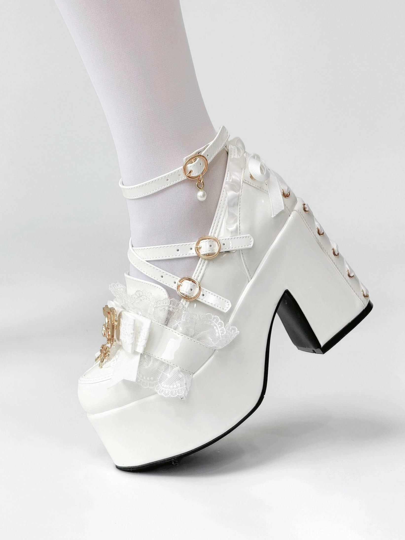Close-up macro detail Jirai Kei platform heel metal buckle fastening mechanism showing secure construction double buckle design safety and structural reliability