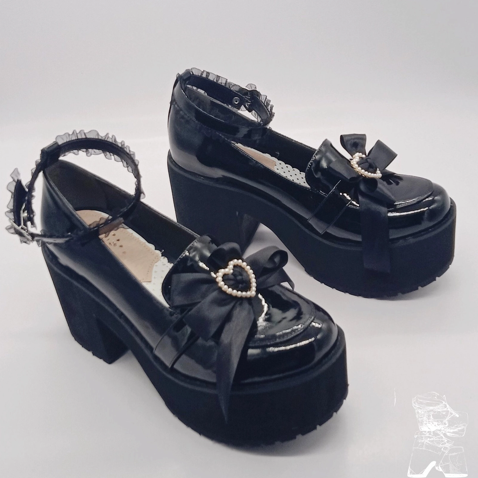 Oblique side view black patent leather platform heels heart pearl bow thick platform sole lace ankle strap detail