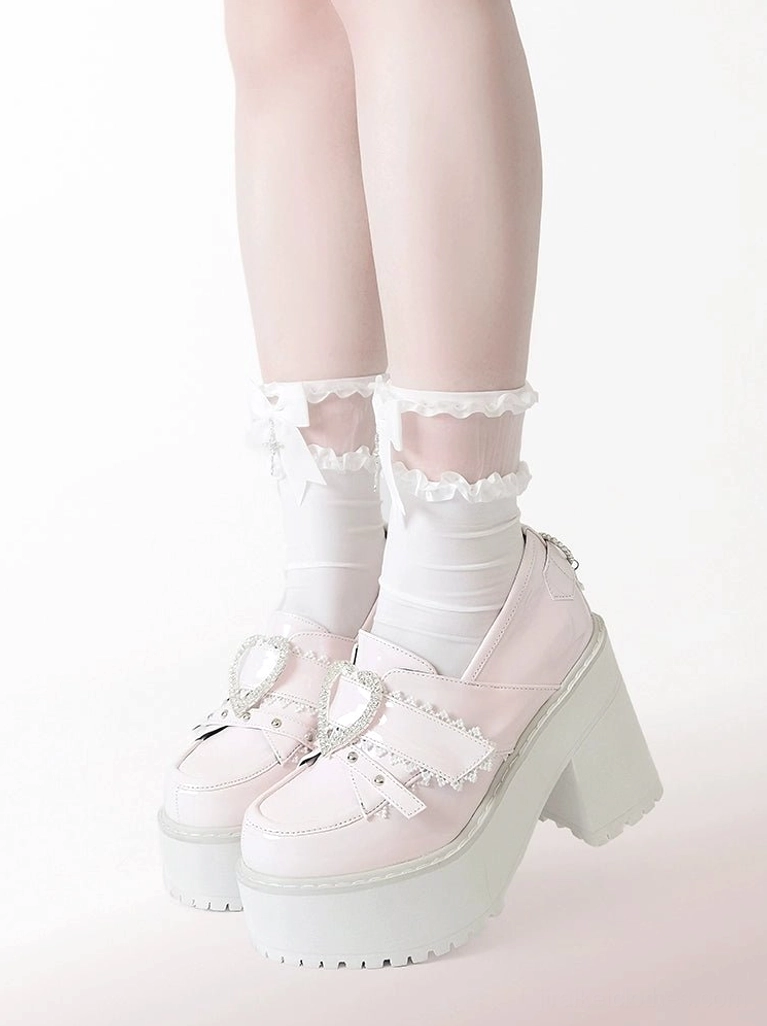 Jirai Kei platform loafers heel back detail showing cross and heart-shaped ornament attachments, decorative accent placement, and customizable element arrangement