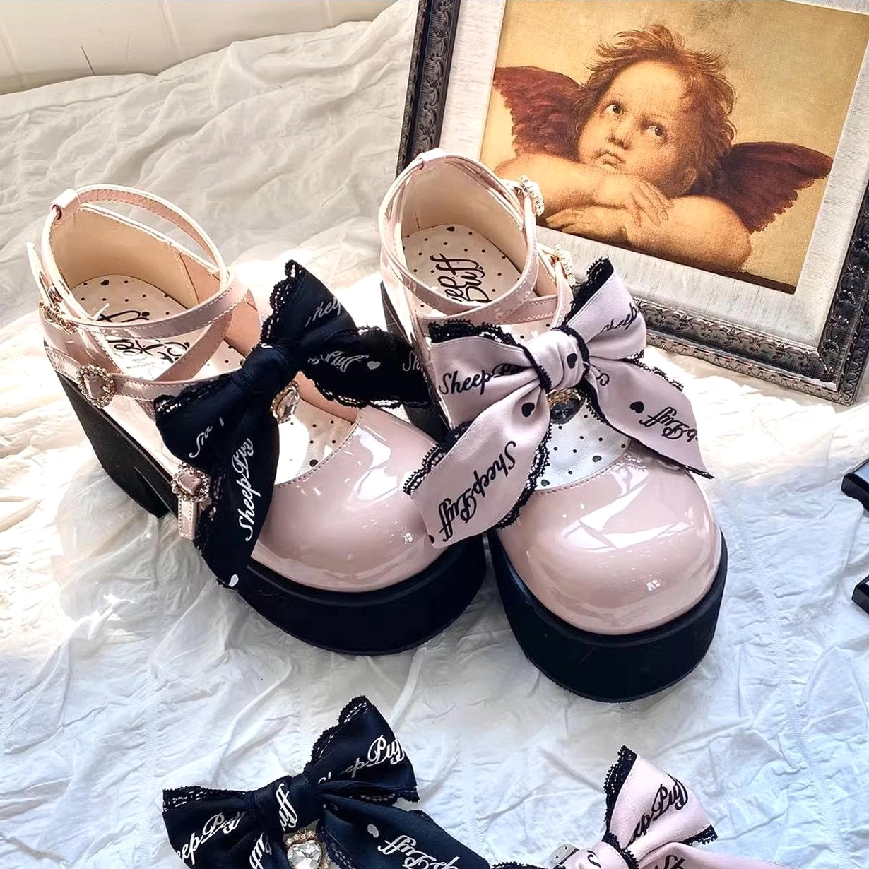 Crisscross buckle strap system detail of platform Mary Jane Jirai Kei shoes showing three-point design, heart-shaped metal hardware, and secure ankle support