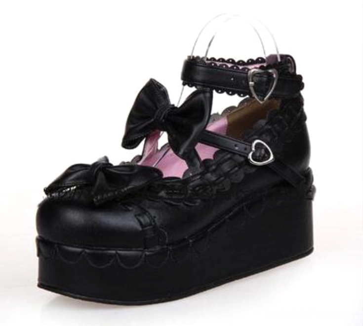 All black Jirai Kei platform shoes with patent leather finish bow decorations and heart ankle buckles side view