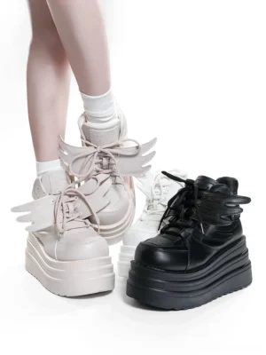 Dual-color high-top platform sneakers with detachable angel wing decorations, low side view showcasing platform height and leg-flattering silhouette