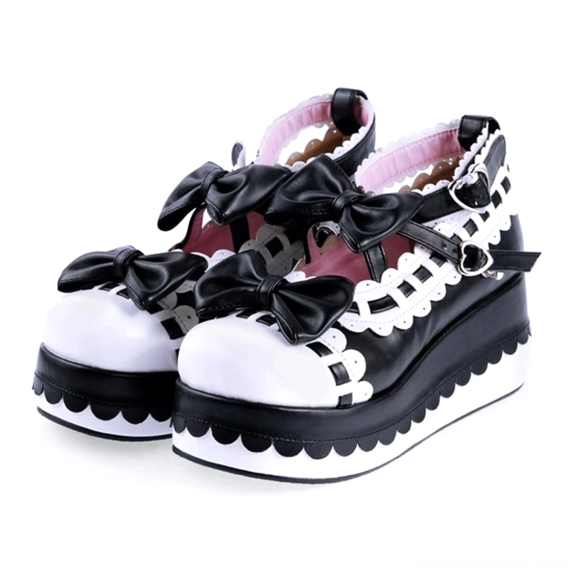 Black white contrast Jirai Kei platform shoes with bow accents and heart-shaped buckles scalloped white soles
