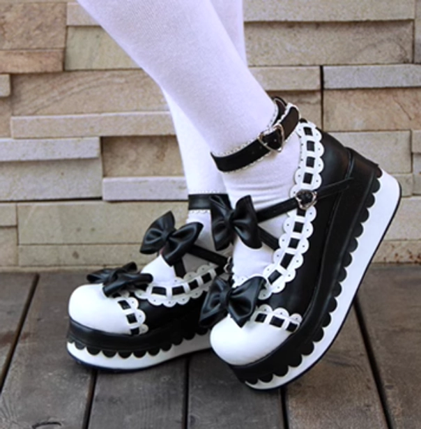 Black white Jirai Kei platform shoes on model legs worn styling wooden floor brick wall background