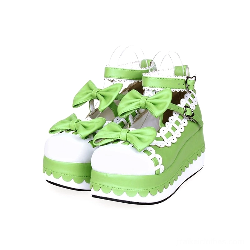 Green white color block Jirai Kei platform shoes with green bow decorations and hardware ankle straps front view