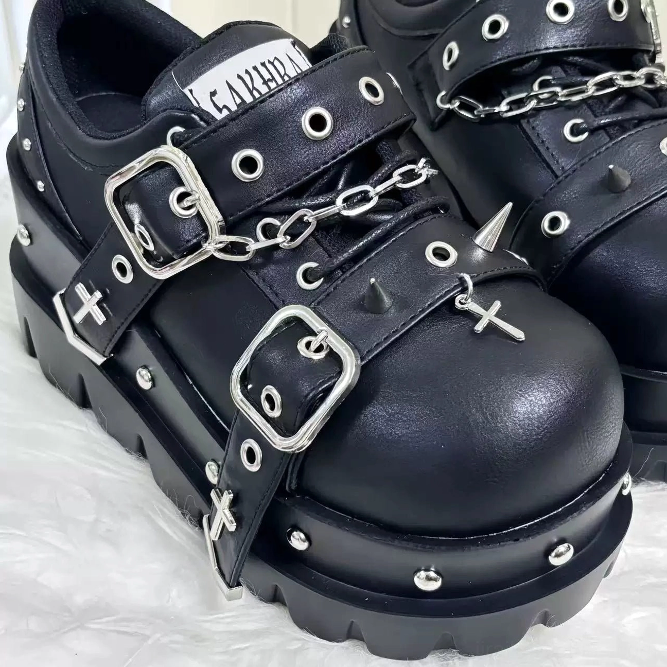 jirai kei black platform shoes close-up side profile matte black leather silver studs buckles chains cross spike decorations