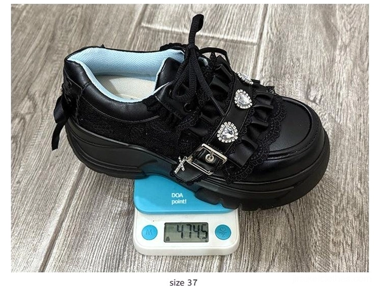 Size 37 black jirai kei platform shoes flat lay wooden surface with digital weight scale heart rhinestone buckle strap
