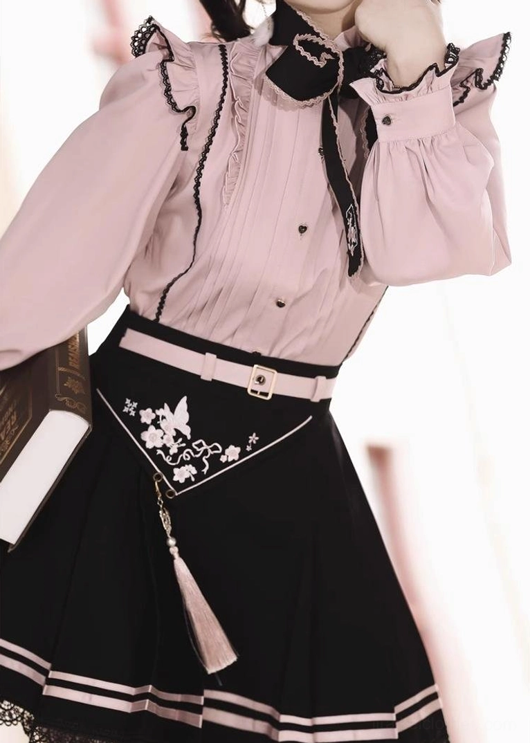 Back view of Jirai Kei skirt featuring light pink floral embroidery at waist, striped trim detail, and black lace hem on neutral plain background