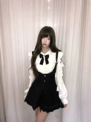 Jirai Kei pleated suspender skirt with ruffled off-shoulder white blouse full-body front view model wearing complete set with black bow collar and heart-shaped buckles