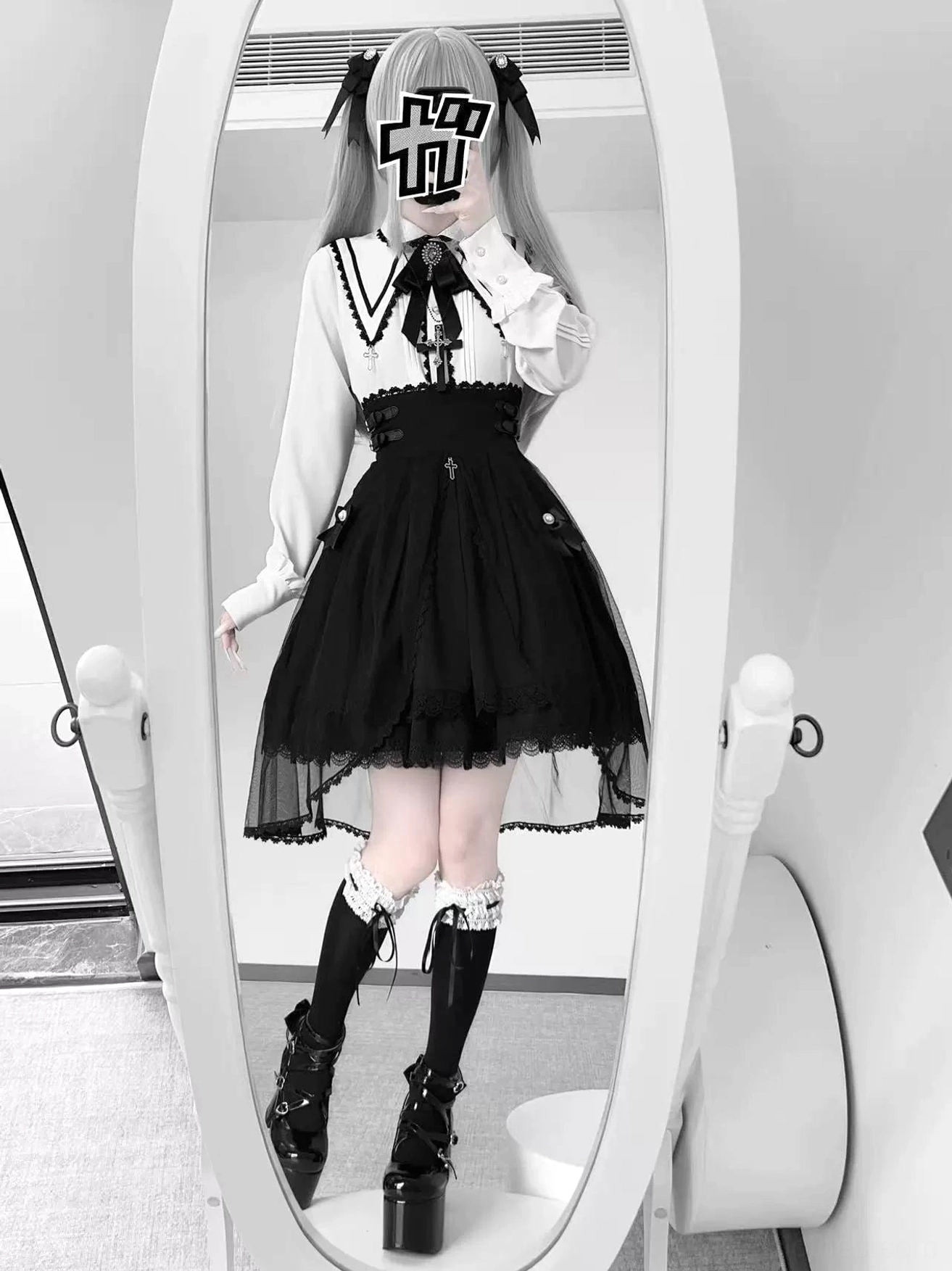 Classic Jirai Kei ensemble featuring white peter pan collar blouse with pointed lapels and black high-waist skirt with sheer lace hem layer, full-body frontal view in indoor mirror setting with platform boots