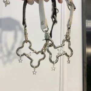 Dual punk choker necklaces featuring silver alloy bone links and star charm dangles in black and white polyurethane leather strap flat lay