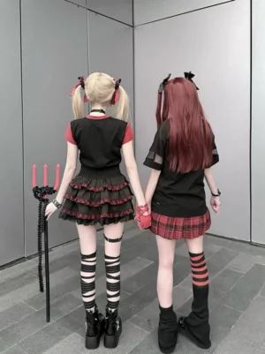 Back view of punk gothic Jirai Kei outfits showcasing color-block graphic tees red plaid layered skirts and striped socks punk aesthetic rear angle