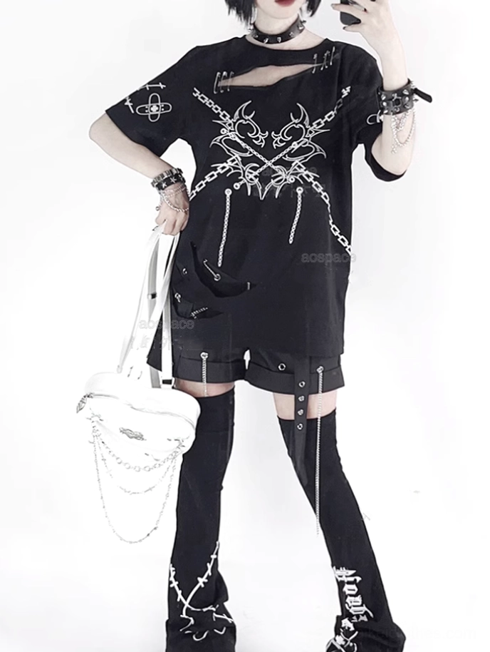 Side profile of black jirai kei punk t-shirt with chest cutout and chain graphics worn by female model with platform boots