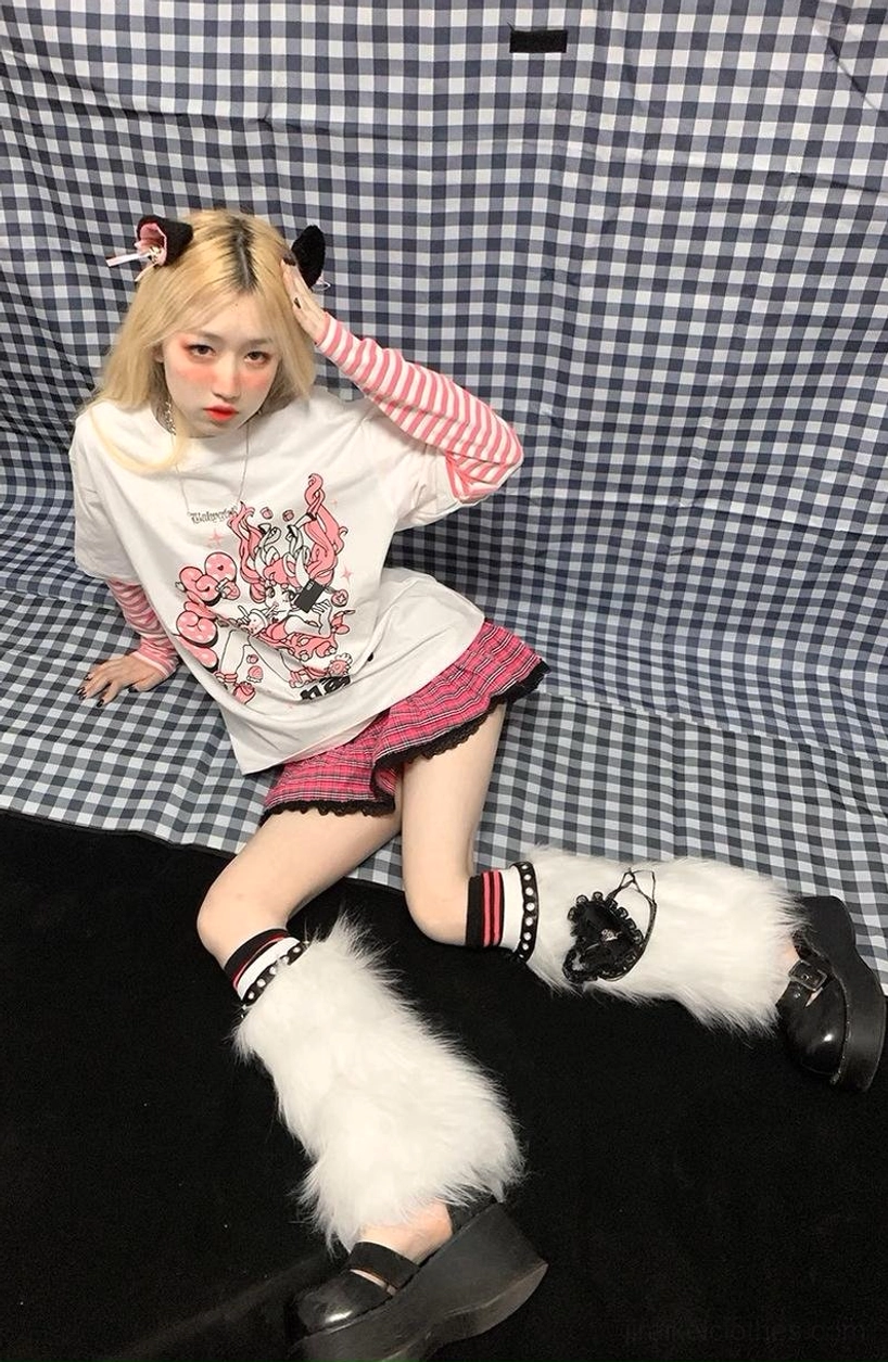Close-up lifestyle shot of jirai kei false two-piece striped long sleeve punk tee graphic print quality and colors