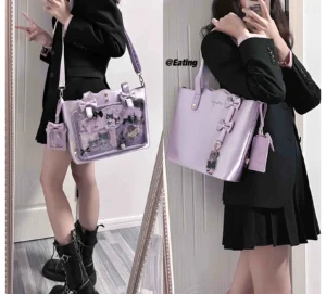 Light purple Jirai Kei ita bag styled in full-body mirror outfit with black blazer and pleated skirt, displaying transparent badge panel with anime character pins and detachable coin purse attachment