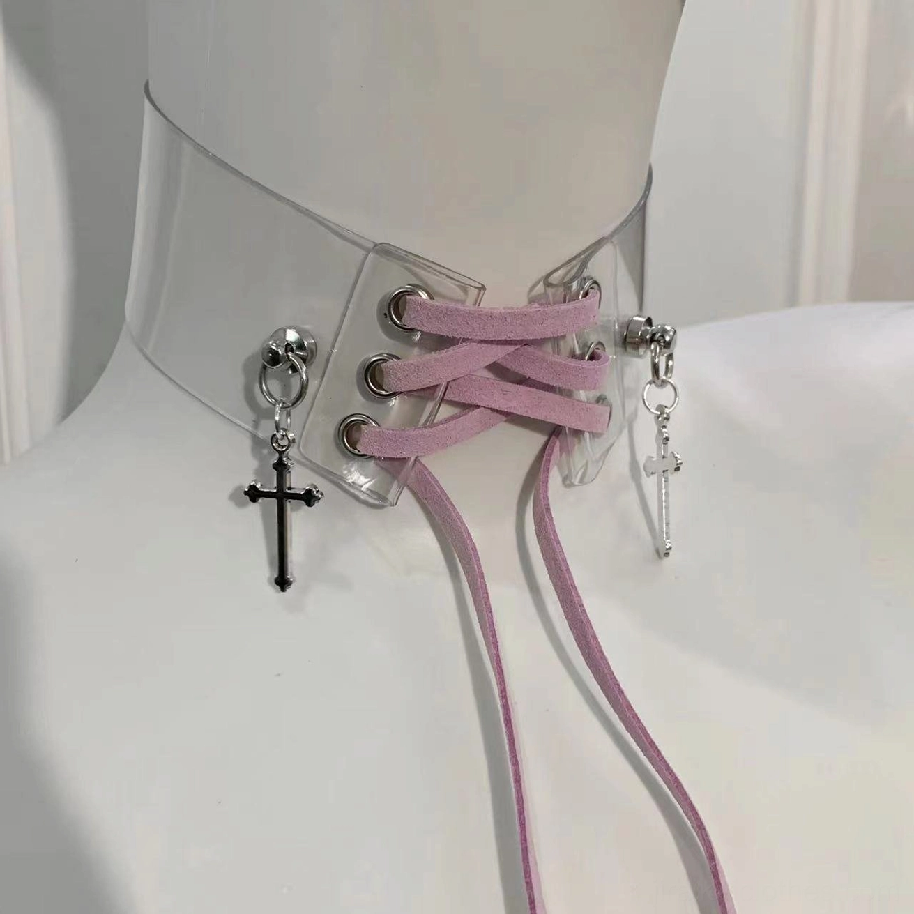 Purple Jirai Kei choker with transparent PU material, mauve pink adjustable straps, and mixed silver and black cross pendants, front view