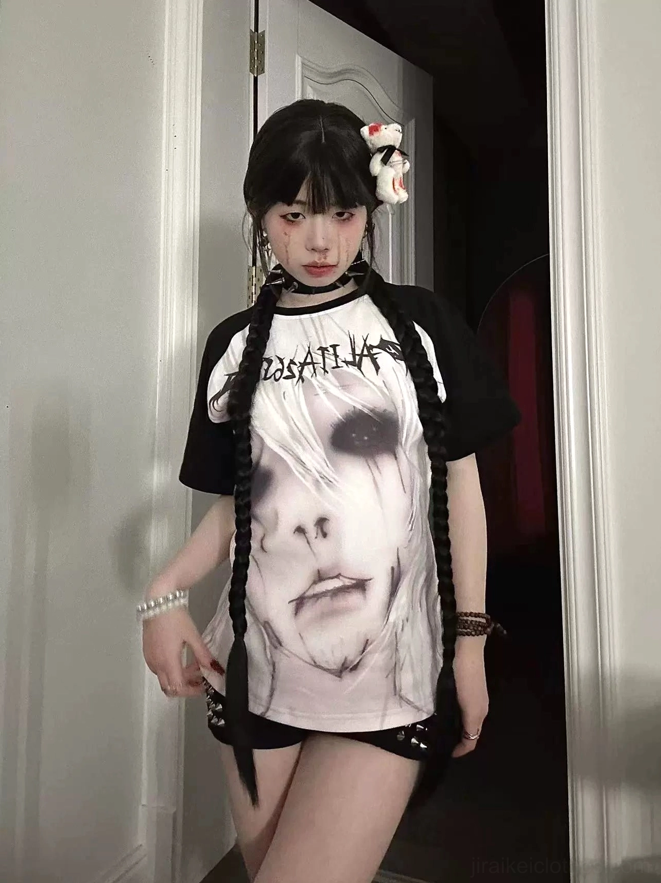 Jirai Kei graphic T-shirt with black raglan sleeves and detailed anime face print on white torso with indoor model styling