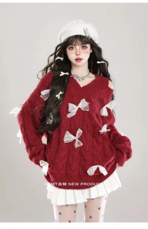 Jirai Kei cold-shoulder fuzzy bow sweater in vibrant red with white ribbon bows, paired with pleated skirt and printed tights, front full-body view showcasing V-neck and asymmetrical design